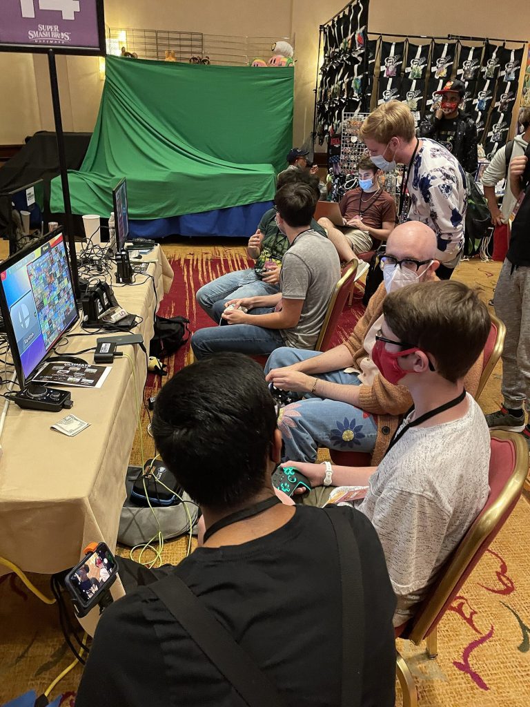 Group of people playing Super Smash Bros. Ultimate at Super Smash Con 2021